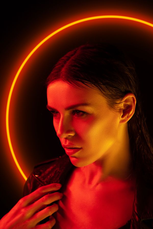 Woman lit by a red neon ring, the WinBeast Reviews UK signature image for the slots, live dealer and table games guide